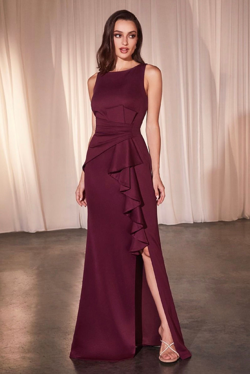 High neck neoprene fitted gown with a cascading ruffle over the slit and pleated waist