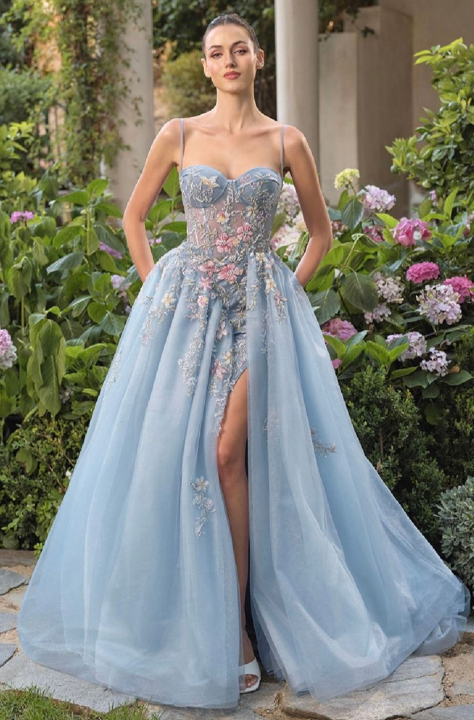 Bustier style corset bodice with straps fitted skirt with asymmetrical ballgown overskirt adorned in beaded flowers