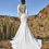 Thumbnail: back view fit n flare crepe wedding gown with a high illusion back, lace side cutouts and long fitted crepe sleeves