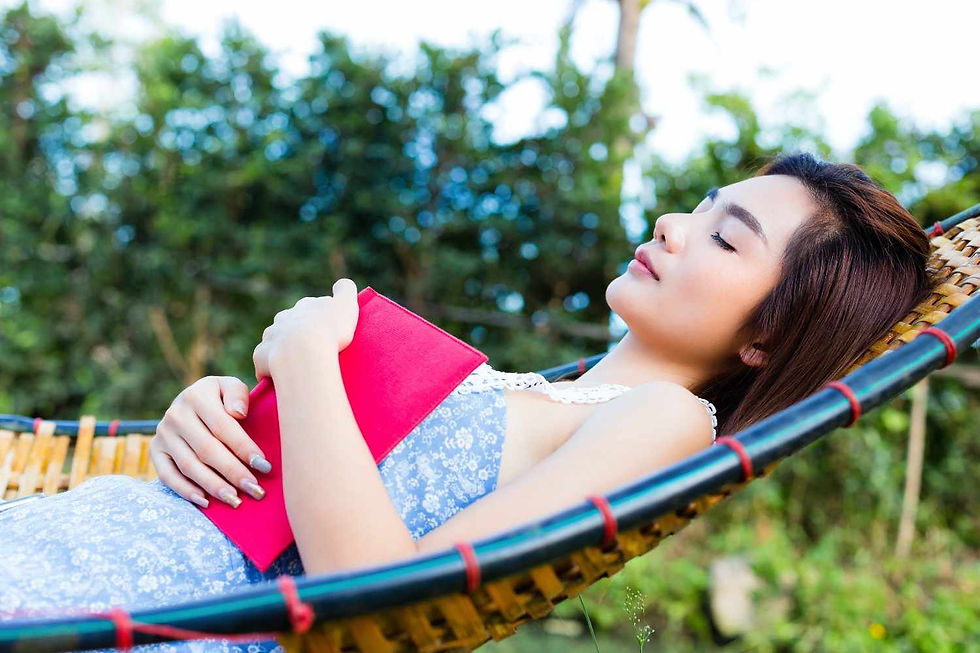 A woman relaxing on a hammock during a meditation retreat