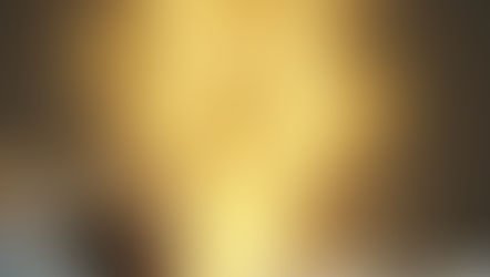 A woman sleeps in bed while a glowing golden figure emanates above, symbolizing her embodying her excellent self during sleep. Dark room, peaceful atmosphere.