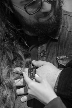 Close-up of a personalized necklace with names and anniversary date worn during an engagement session at Powder Mill Park, Rochester NY