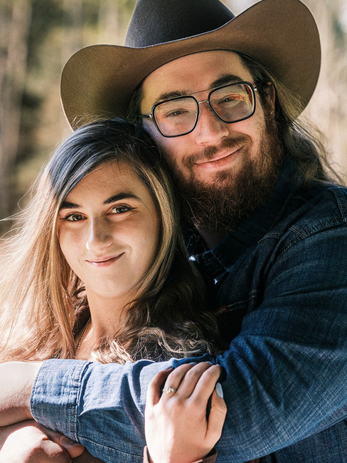 Couple in country-themed engagement photos at Powder Mill Park in Rochester NY — coordinated denim, worn boots, and natural film photography by Nostalgia Nomad