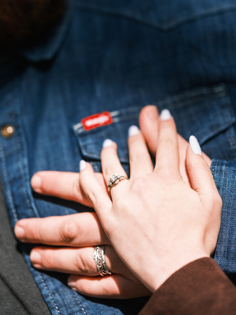 Matching engagement rings from a double proposal, photographed during a country-themed engagement se
