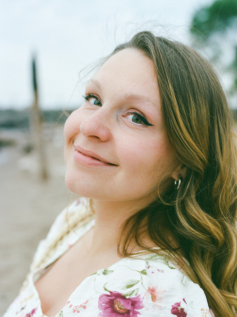 Film portrait of expecting mother on Lake Ontario shoreline, soft evening light