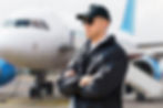 Secuirty man standing in front of a plane on a airports tarmac