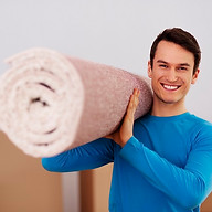 happy-male-carrying-carpet-new-home.jpg