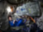 Astrunaut sitting a space simulator alone