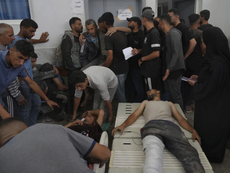 Palestinians hurt the night before while attempting to reach humanitarian aid are brought to Gaza City’s al-Shifa Hospital on Wednesday, June 11, 2025