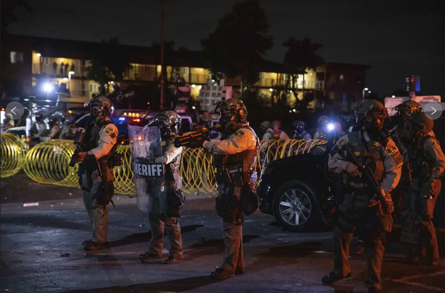 Members of the National Guard faced off with protesters in Los Angeles on Sunday, and tear gas was fired at a growing crowd that gathered outside a federal complex hours after the federal troops arrived in the city on President Donald Trump’s orders. (AP video: Eugene Garcia)