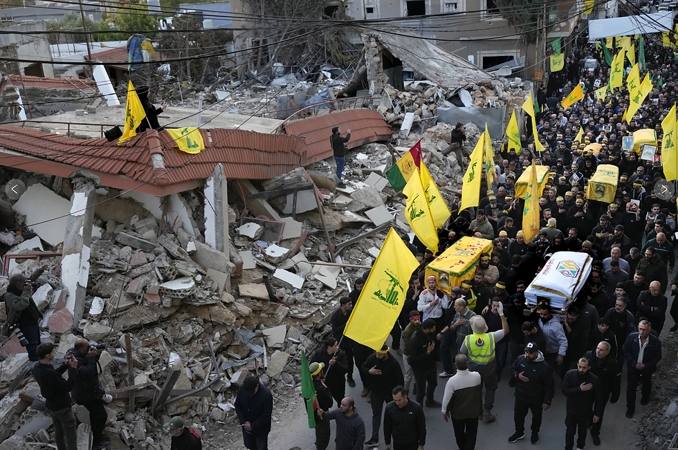 Mourners carry the coffins of Hezbollah fighters killed in the fighting against Israeli troops past a destroyed building in Maarakeh village, southern Lebanon, on Nov. 29, 2024.(AP Photo/Hussein Malla, File)