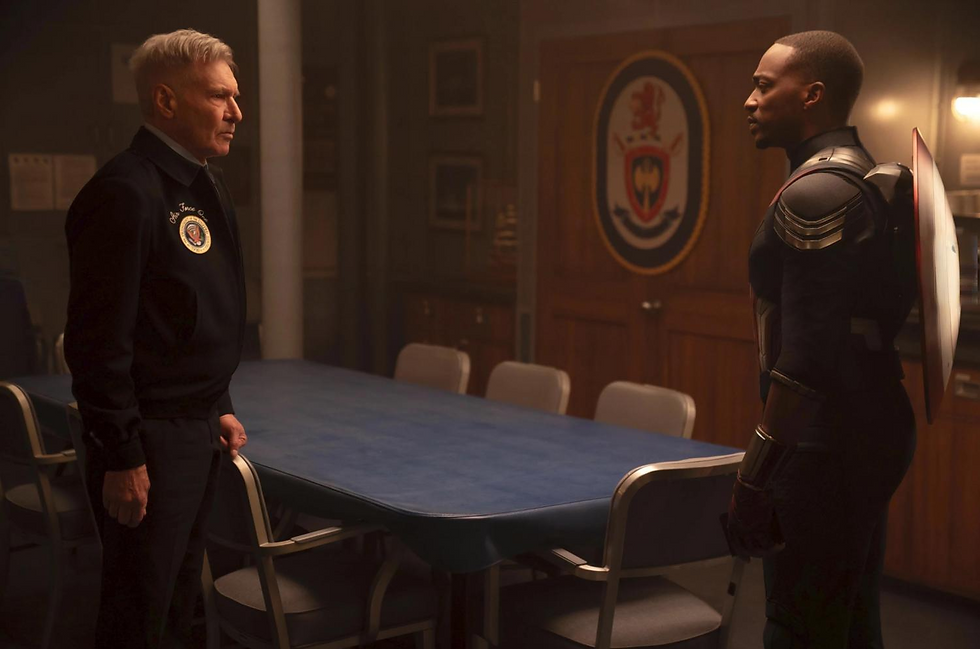 Two men face each other in a dimly lit room with a blue table and chairs. One wears a uniform with a badge, the other a tactical suit, carrying a shield. Tense mood.