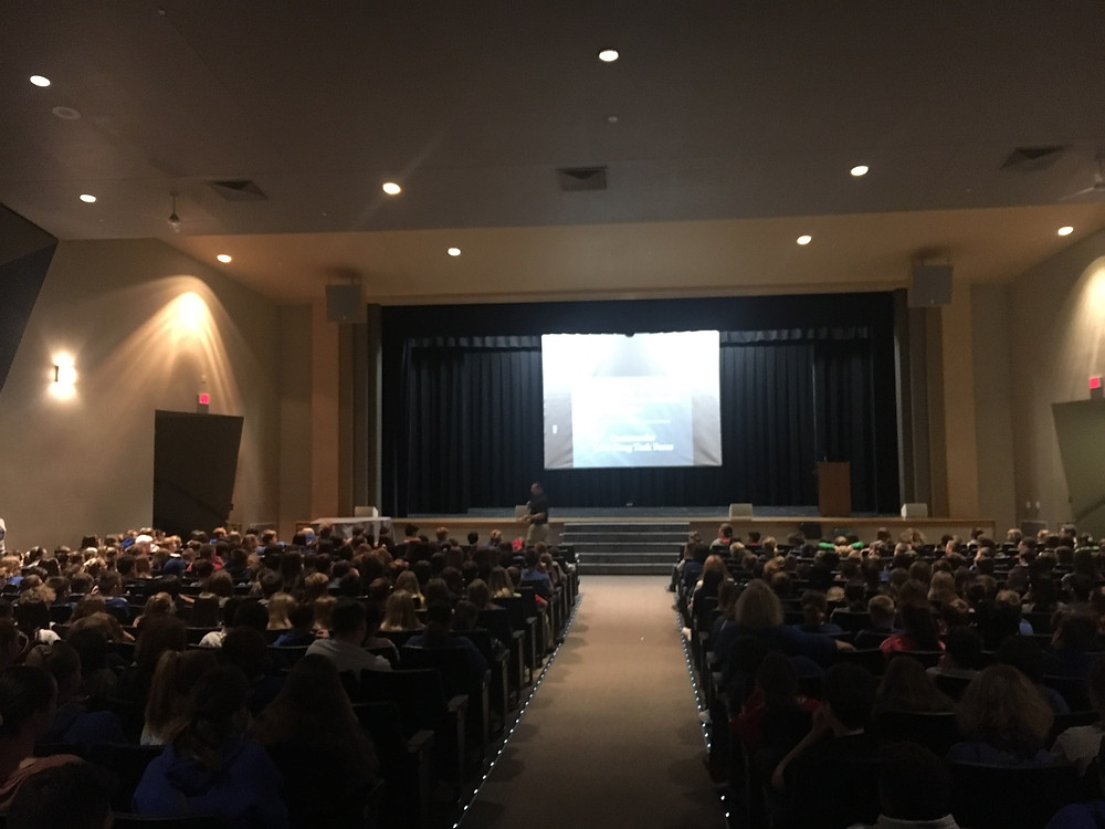 Students in the auditorium listening to a presenter.