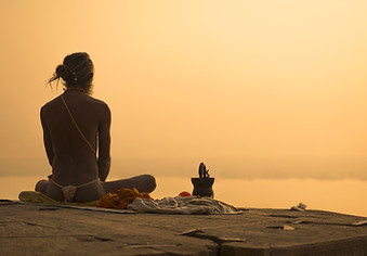 Indian Priest Meditating at Sunset