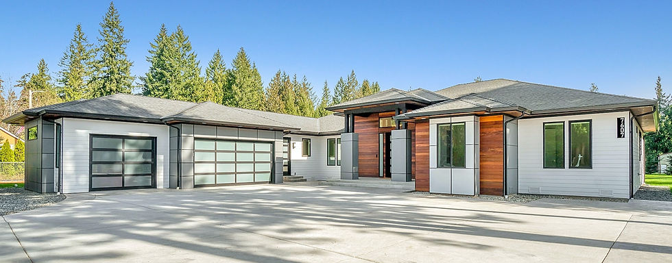 photograph of a large suburban house house with wood siding, big garage, vast driveway, wood siding, hip roof, and a forest beyond, summer