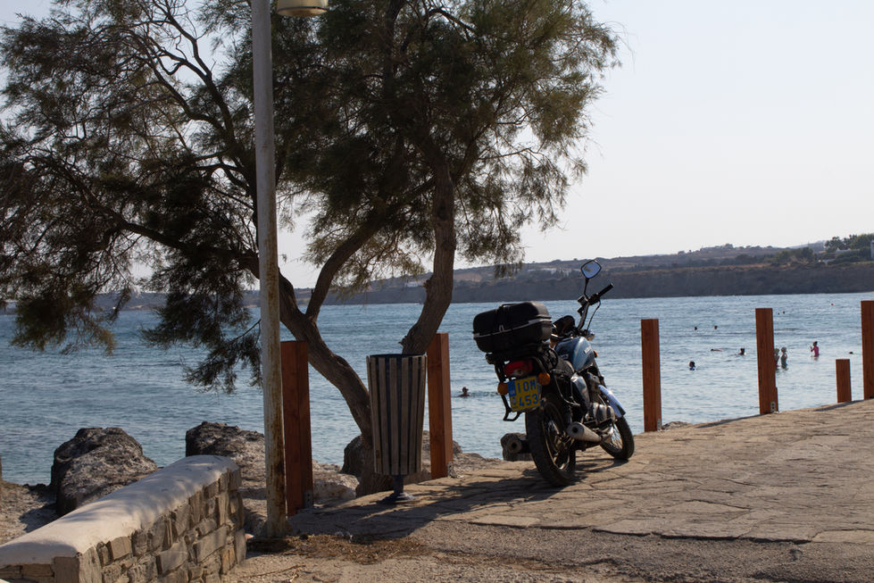 photograph of a motorcycle with water behind it. 