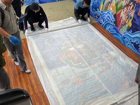 Orient Relocation employees carefully wrapping a Thangka painting to ensure its safe transport.