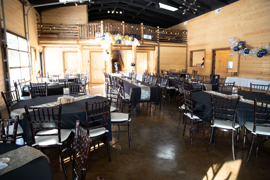 Wedding reception with round and banquet tables at The Dogwood Gardens wedding venue in Peculiar Missouri near Kansas City.