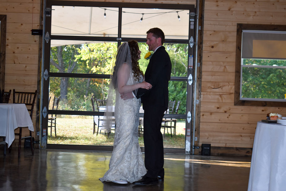 Couple sharing first dance in reception hall at The Dogwood Gardens wedding venue in Peculiar Missouri near Kansas City.