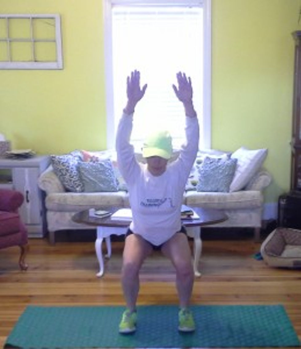 Keep your chest up as you push your hips back and sink into a squat. Your arms should remain behind your ears (or as close as possible). Your knees should remain on top of your ankles but BEHIND YOUR TOES at all times.
