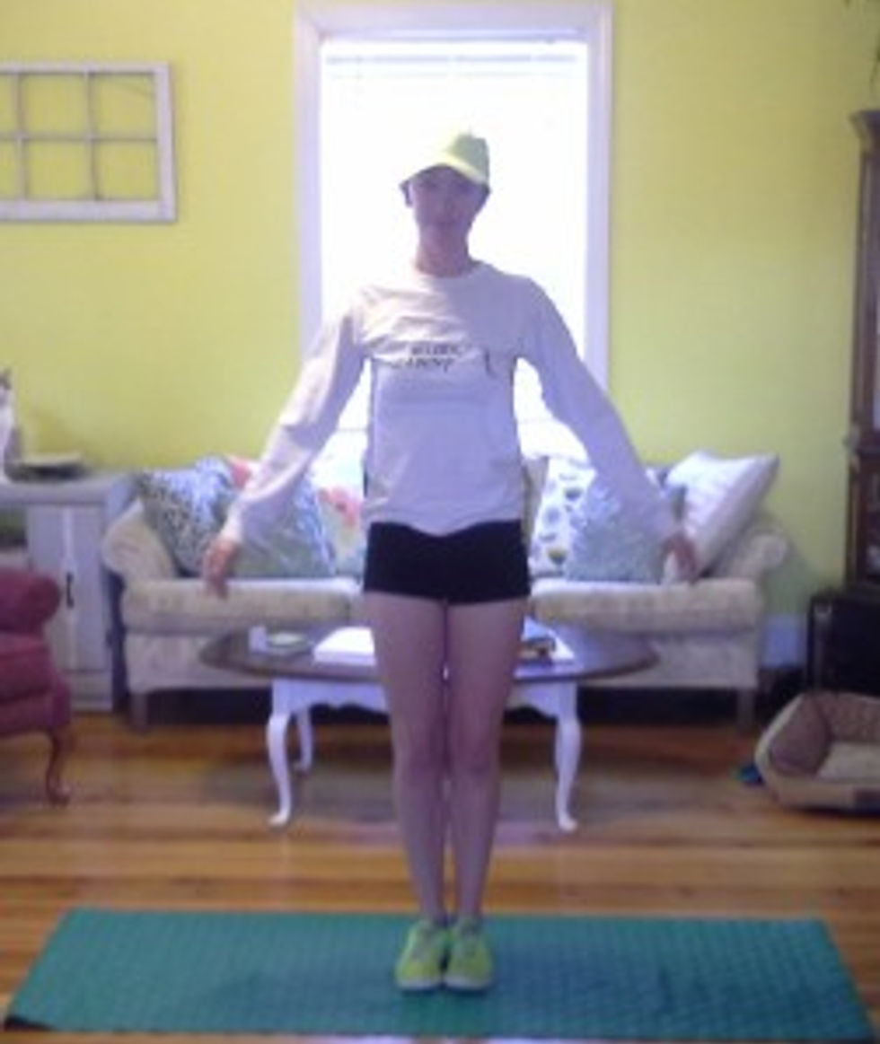 Stand tall with arms down and legs together.