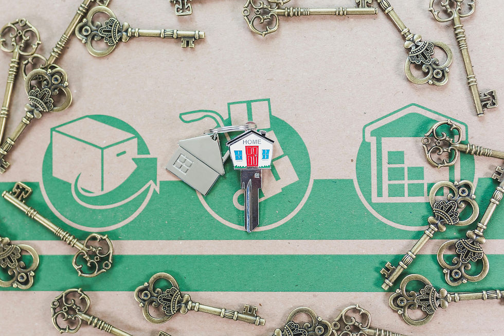 House keys on top of a box showing move-in process of buying a house. Picture aims to promote real estate investments.