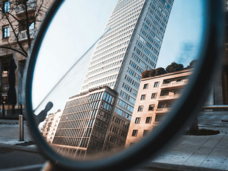 Mirror looking at a high rise development.