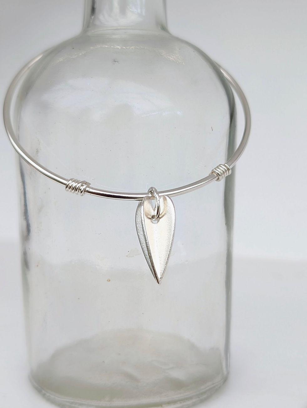 Thumbnail: ladies silver bangle with a geometric silver heart