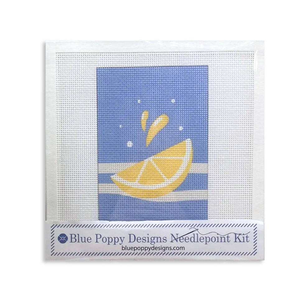 Box view of lemon wedge hand painted needlepoint kit of a lemon wedge with juice squirt on a field of blue and white