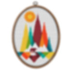 Colorfu sun over moutains and a bear in 70's color scheme cross stitch kit