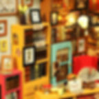 close up view of a section of sams study diy mini house kit shows bookshelves full of books, framed pictures, a sale sign