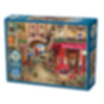Box of 500 piece cobble hill random quirky cut puzzle of a morning outside a Paris cafe with the eiffel tower in the distance
