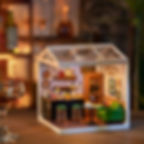 Leisurely Cheers Bar Miniature dollhouse with LED light on, sitting on a counter