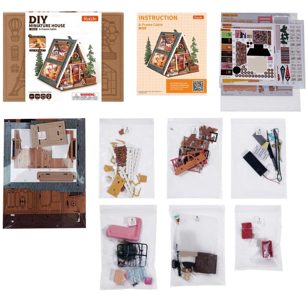 Thumbnail: layflat of included components of A-Frame cabin kit with instructions, paper, stickers, lighting, wooden parts in baggies