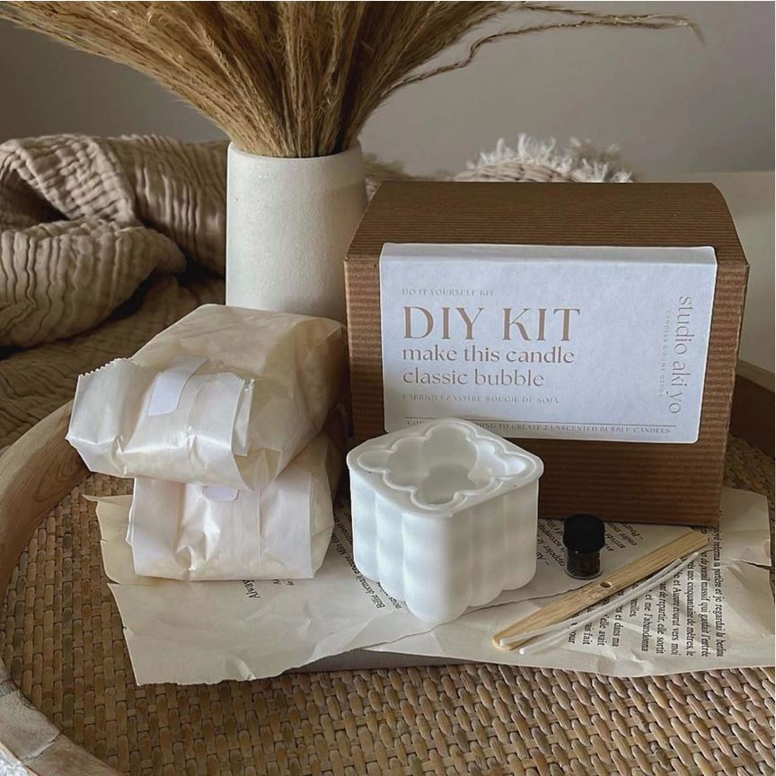 Thumbnail: Mold and the included soy wax, wick and wick holder for unscented bubble candles from this DIY kit in ivory and cappuccino