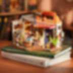 Finished corner bookstore miniature model on a stack of books