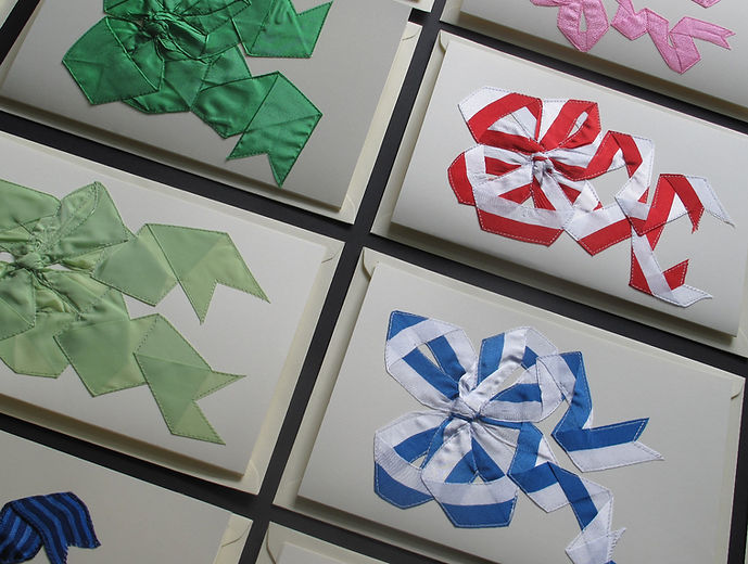 Silk ribbons with different textures are stitched by Nina Grüninger onto greetings cards, all for sale.