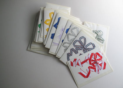 Packaged handmade cards stacked on a table ready to be sold and shipped. Stock for shops, wholesale.