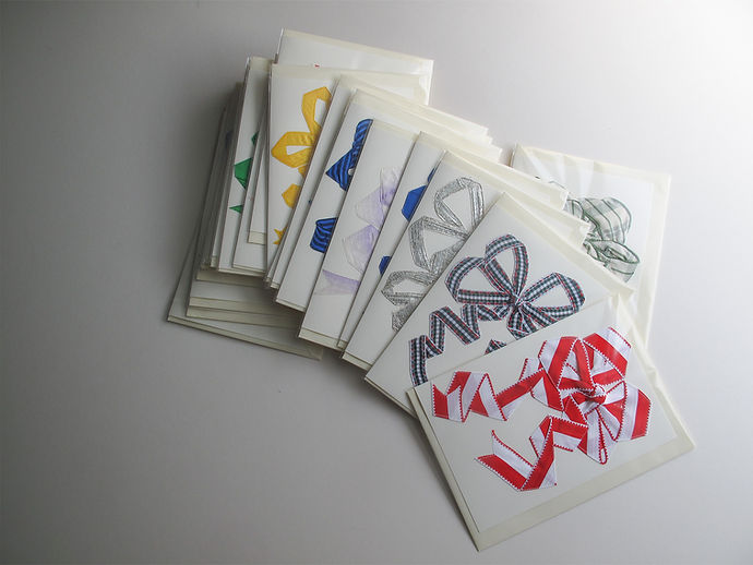 Packaged handmade cards stacked on a table ready to be sold and shipped. Stock for shops, wholesale.