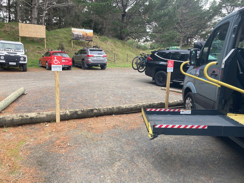 Disabled parking spaces on gravel road with mobility van ramp extended