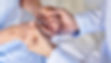 Hands of a senior woman hold in bereavement for comfort and sympathy in the care of the el