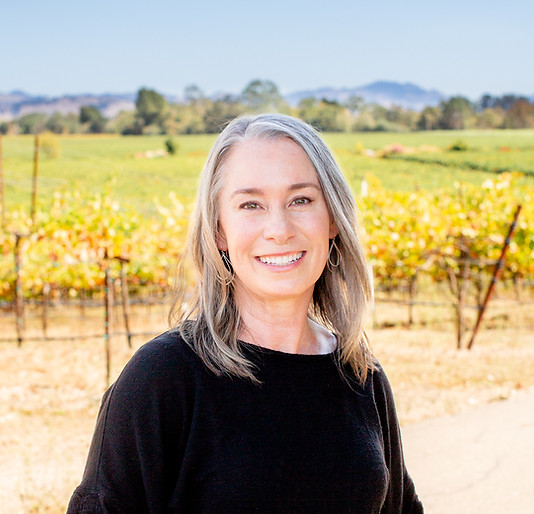 Dr. Solomon standing in front of a vineyard