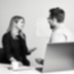 both woman man speaking to a client regarding prototype for web design black and white wit