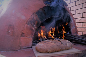 Outdoor wood fire piza oven baking gourmet bread