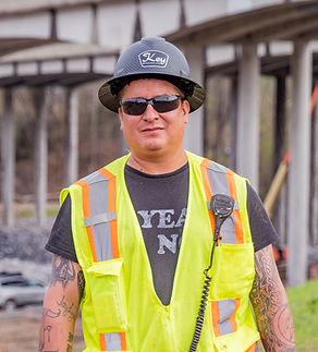 Construction team member in a hard hat and safety vest.