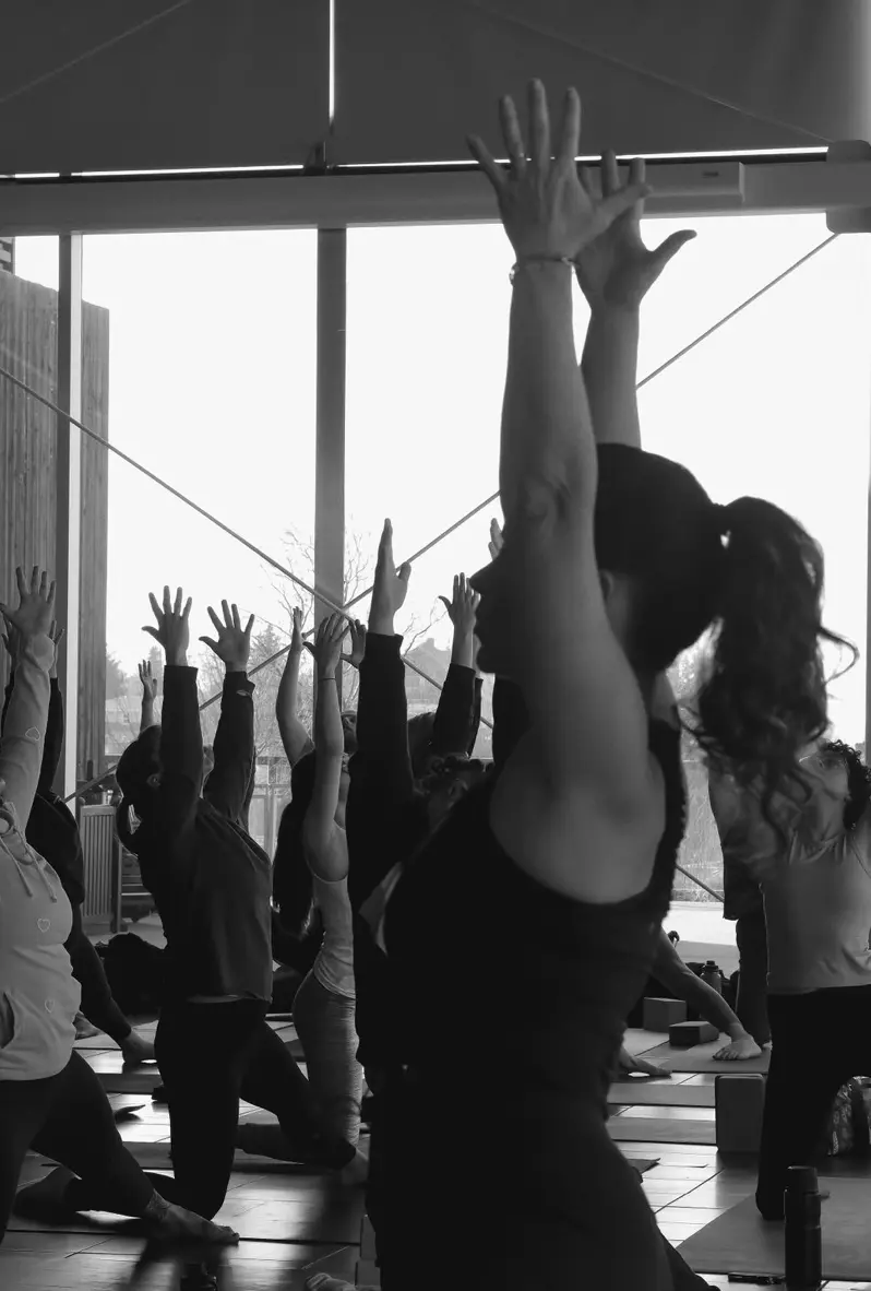 Participants in inclusive community yoga classes reach up.