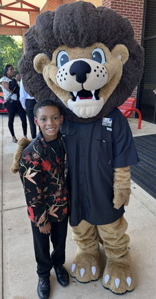 Child and ADAC mascot Leo the Drug-Free Lion at E.G.O. Experience in Diboll, TX