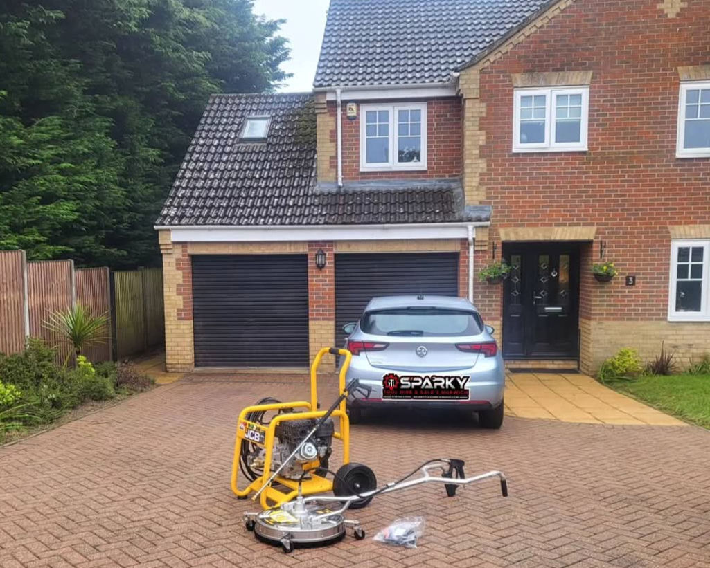 Yellow pressure washer, surface cleaner on block paved driveway, MARK V car.