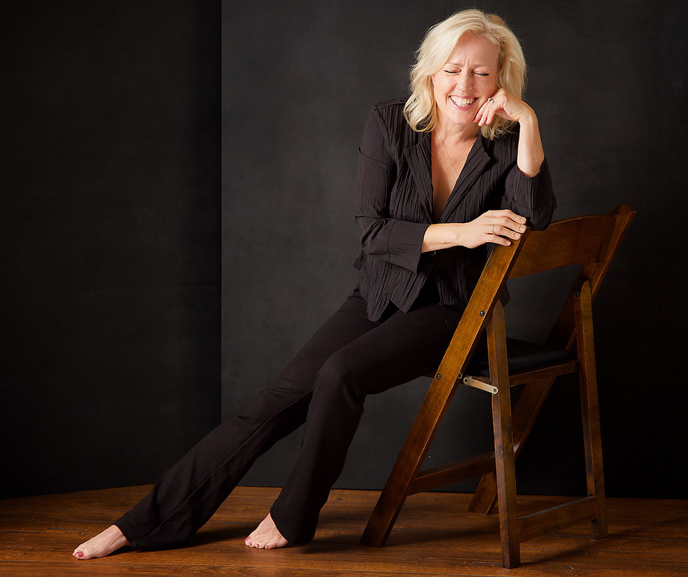 An empowering self love photoshoot for a woman entrepreneur wearing blank pants and a jacket with blonde hair sitting iand laughing out loud for a healing photography session at portrait by Taru Studio by a female photographer in Plymouth Minneapolis Minnesota MN, Midwest who started Journeys Of women Portrait Series to show the power, wisdom and grace of a woman.