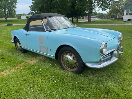 1959 Alfa Romeo Giulietta Spider Veloce, light blue convertible, parked on grass